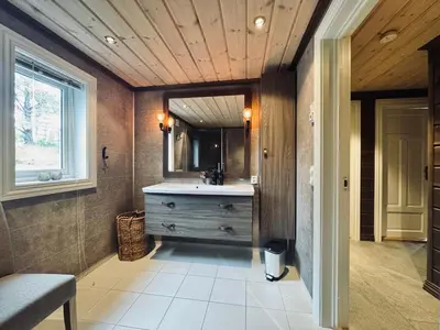 a bathroom with a sink and a mirror at Spacious cabin in the mountains in Gol