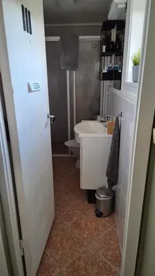 a small bathroom with a sink and a toilet at Charming family house with beautiful views! in Askøy