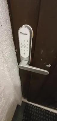 a remote control hanging on the side of a wall at Fotlandsvåg Guest Apartment in Bernes