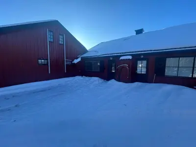 a snow covered building with a snow pile next to it at Nice apartment at Golsfjellet in Gol