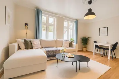 a living room with a couch and a table at Apartment Bergen Center - Quiet Gem - Norwegians Minimum Age 25 in Bergen