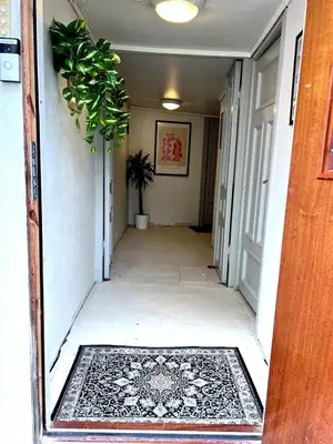 a hallway of a house with a rug and a plant at Apartment Bergen Center - Quiet Gem - Norwegians Minimum Age 25 in Bergen