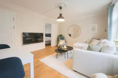 a living room with a white couch and a table at Apartment Bergen Center - Quiet Gem - Norwegians Minimum Age 25 in Bergen