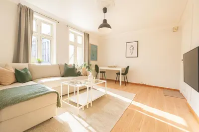 a living room with a couch and a table at Central & Quiet by Bryggen - Norwegians Minimum Age 25 in Bergen