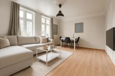 a living room with a couch and a table at Central & Quiet by Bryggen - Norwegians Minimum Age 25 in Bergen