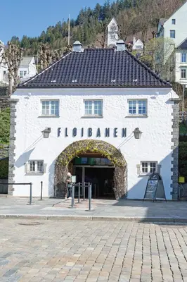 a white building with an archway in front of it at Delightful Bryggen Apartment - Norwegians Minimum Age 25 in Bergen