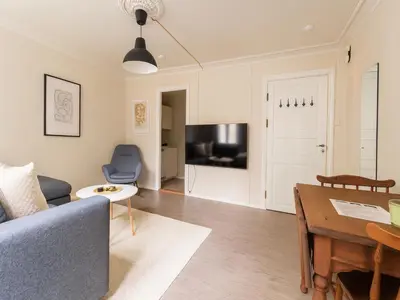 a living room with a couch and a table at Twin Flats 1st Floor in Bergen Centre - Norwegians Minimum Age 25 in Bergen