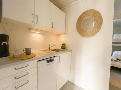 a kitchen with white cabinets and a sink at Twin Flats 1st Floor in Bergen Centre - Norwegians Minimum Age 25 in Bergen