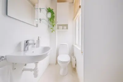 a white bathroom with a sink and a toilet at Twin Flats 1st Floor in Bergen Centre - Norwegians Minimum Age 25 in Bergen