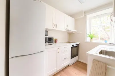 a kitchen with white cabinets and a sink at Trio Central in centre - Norwegians Minimum Age 25 in Bergen