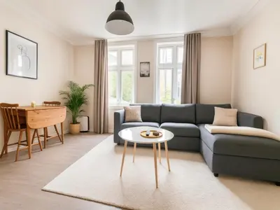 a living room with a blue couch and a table at Trio Central in centre - Norwegians Minimum Age 25 in Bergen
