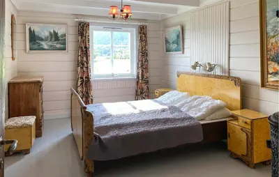 a bedroom with a bed and a window at Lovely Home In Fiksdalen in Fiksdal