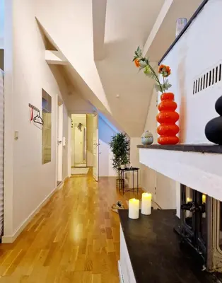 a living room with a fireplace with a vase on the mantle at King bed Great location Top floor in Bergen