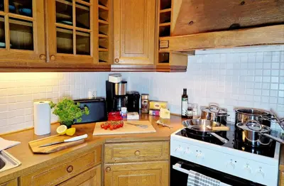 a kitchen with wooden cabinets and a counter top at King bed Great location Top floor in Bergen