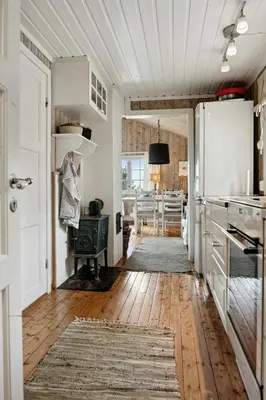 a kitchen with a refrigerator and a wooden floor at Charming Cabin By Nesfjellet Ski Resort in Nesbyen