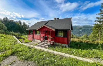 a red tiny house on a hill in a field at 3 Bedroom Stunning Home In Sør-Fron in Sør-Fron