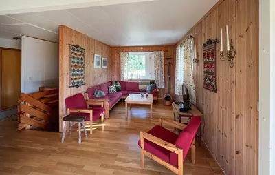 a living room with a couch and a table and chairs at 3 Bedroom Stunning Home In Sør-Fron in Sør-Fron