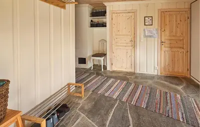 a room with two wooden doors and a rug at Awesome Home In Eggedal With Sauna in Eggedal