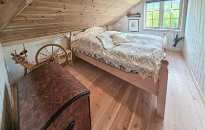 a bedroom with a bed and a wooden ceiling at Awesome Home In Eggedal With Sauna in Eggedal