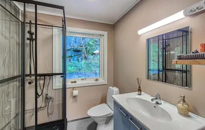 a bathroom with a shower toilet and a sink at Awesome Home In Eidfjord With House Sea View in Eidfjord