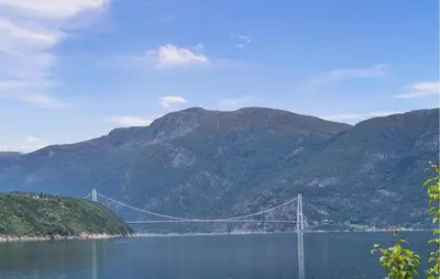 a bridge over a body of water with mountains at Awesome Home In Eidfjord With House Sea View in Eidfjord