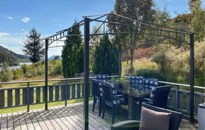 a patio with a table and chairs on a deck at Stunning Home In Korssund With Wifi in Korssund