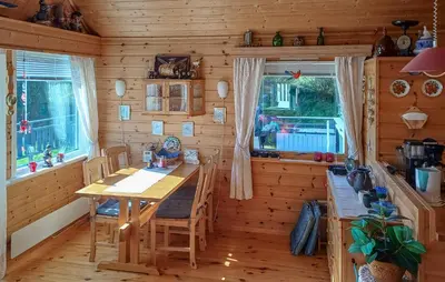 a dining room with a wooden table in a cabin at Stunning Home In Korssund With Wifi in Korssund