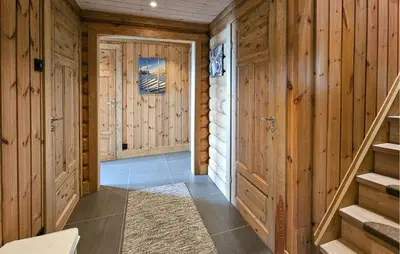 a hallway with wooden walls and stairs in a house at Nice Home In Gol With Sauna in Gol