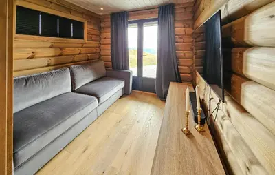 a living room with a couch in a log cabin at Nice Home In Gol With Sauna in Gol