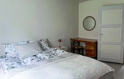 a bedroom with a bed and a mirror and a dresser at Gorgeous Home In Eikesdal - N28170 in Verma