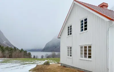 a white building with a red roof next to a lake at Gorgeous Home In Eikesdal - N28170 in Verma
