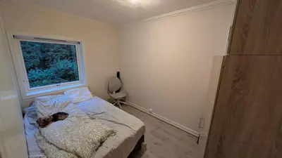 a child laying on a bed in a bedroom at 2 Bedroom central apartment in Bergen