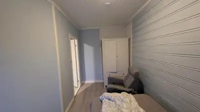 a bedroom with blue walls and a bed and a window at 2 Bedroom central apartment in Bergen