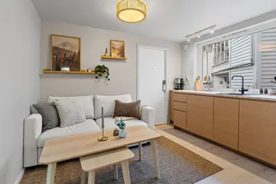 a living room with a couch and a table at Modern Apartment in the Heart of Bergen in Bergen