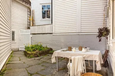 a table in the courtyard of a house at Modern Apartment in the Heart of Bergen in Bergen