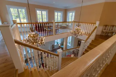 a staircase in a home with chandeliers at Villa Grøndalen Gård in Trysil