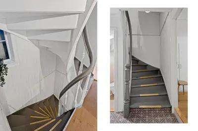 a staircase in a house with white walls at Large Historic Apartment in the best part of Bergen in Bergen