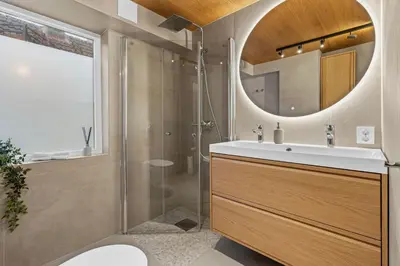 a bathroom with a sink and a shower at Large Historic Apartment in the best part of Bergen in Bergen