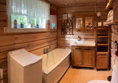 a bathroom with a tub and a sink at Traditional Log Cabin By Lake Mykletjønn in Austbygdi