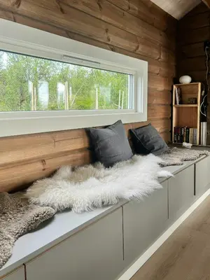 a room with two benches with a window at Mountain Cabin With Great Ski Terrain in Vingelen