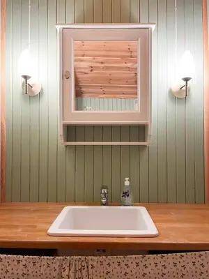 a bathroom with a white sink and a mirror at Modernized Log Cabin At Ljøsheim in Sjusjøen