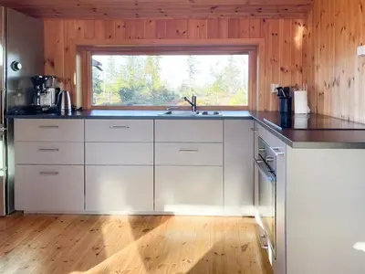 a kitchen with a sink and a window at Modernized Log Cabin At Ljøsheim in Sjusjøen