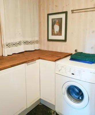a laundry room with a washer and dryer at Spacious Family Cabin With Views In Hafjell in Øyer