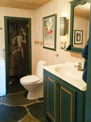 a bathroom with a toilet and a sink at Spacious Family Cabin With Views In Hafjell in Øyer
