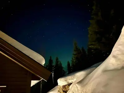a snow covered roof of a house at night at Family Cabin With Views In Lygnalia in Jaren