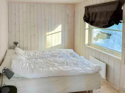 a white bed in a room with a window at Family Cabin With Views In Lygnalia in Jaren