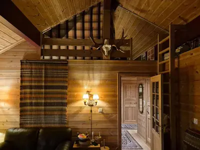 a living room with wood paneling and a ceiling at Authentic Cabin Overlooking Lake Møsvann in Rjukan