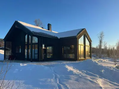 a building covered in snow in the snow at Mountain Cabin With Beautiful Lake View in Hemsedal