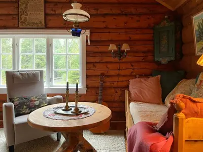 a room with a table in a log cabin at Traditional Log Cabin By Lake Seljord in Seljord