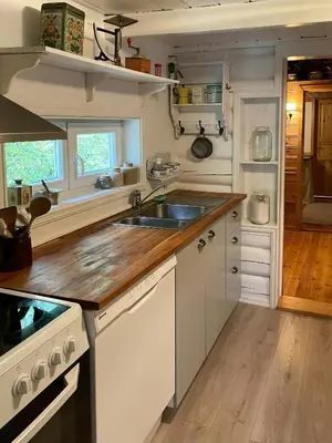 a kitchen with a sink and a stove at Traditional Log Cabin By Lake Seljord in Seljord